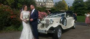Couple with wedding car at The Sun Pavillion